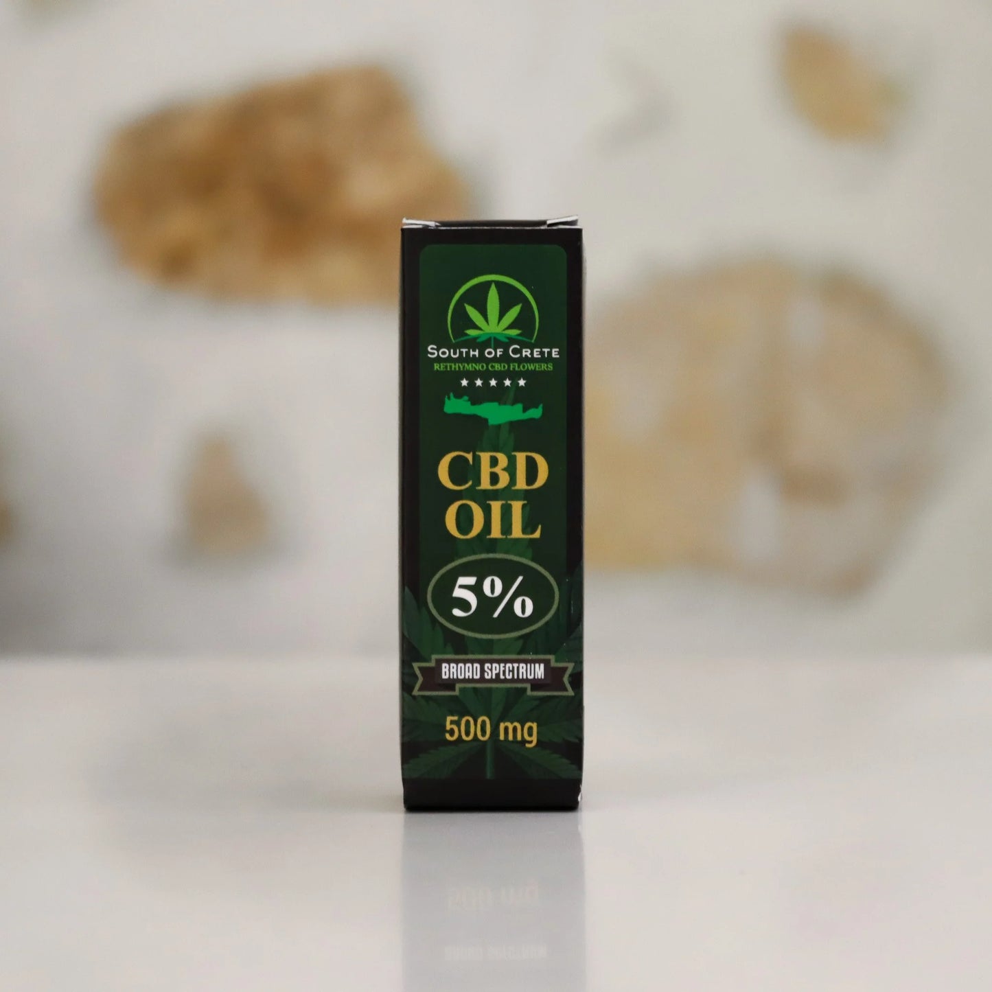 CBD oil packaging with 'South of Crete' branding on a blurred background